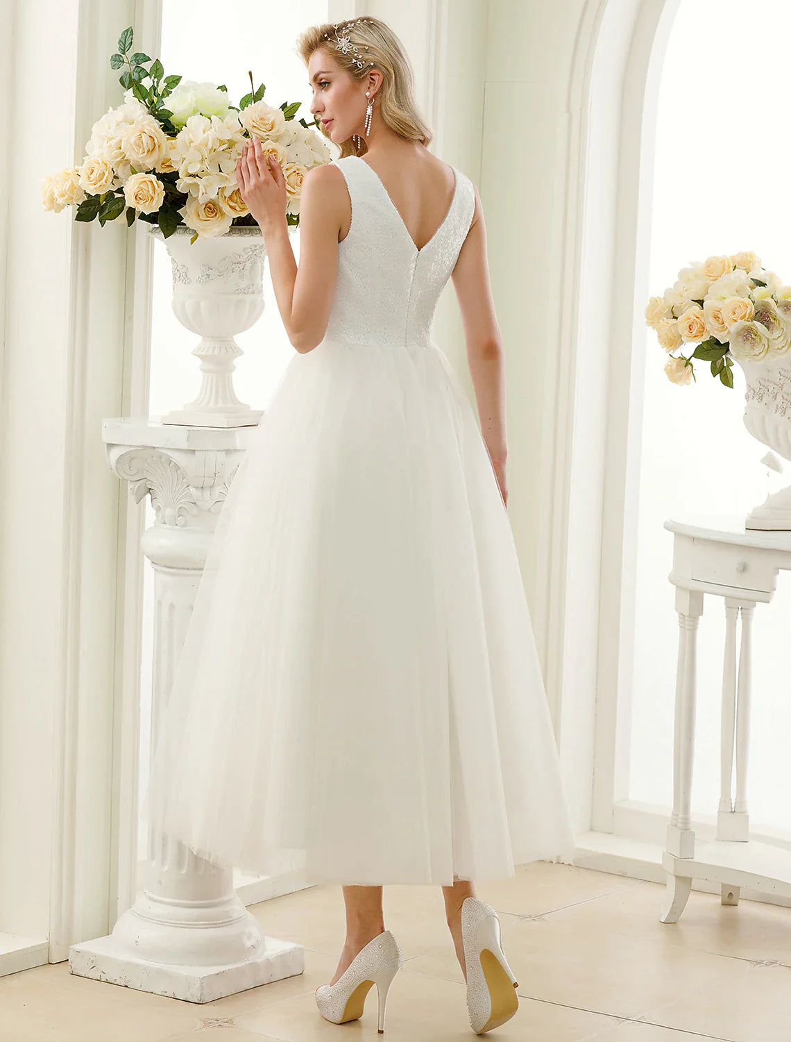 Side profile of the bride in the sparkling lace and sequin reception dress.
