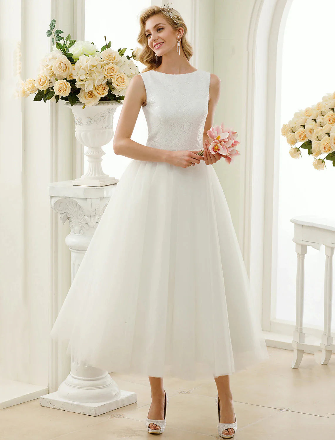 Full view of the tea length wedding dress, highlighting its A-line silhouette.