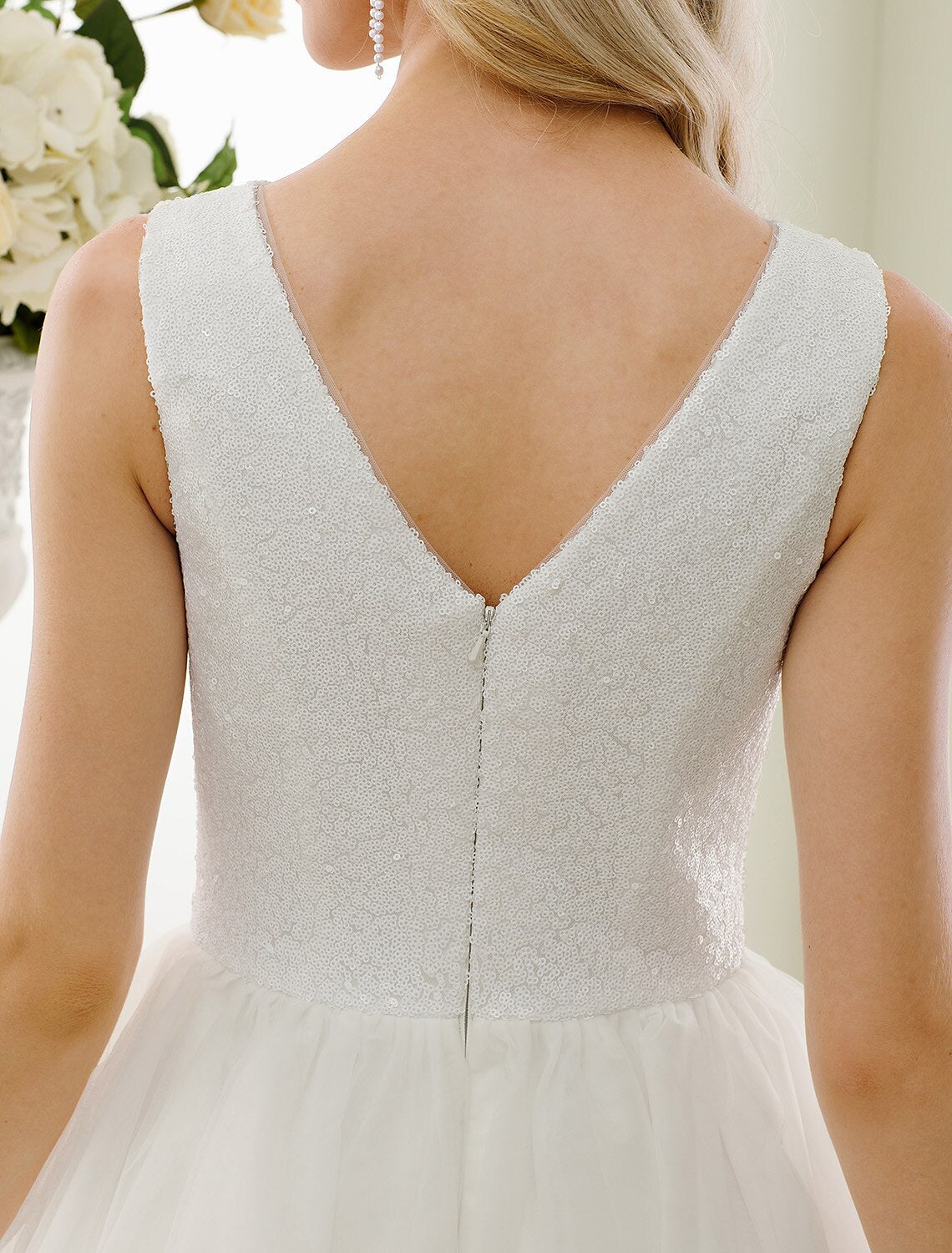 Detail of the intricate lace and sequin embellishments on the tulle fabric.