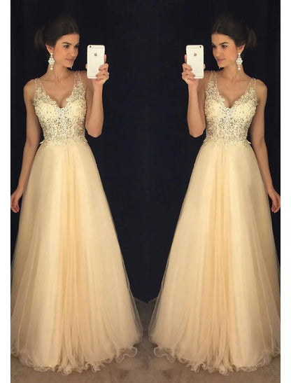 Model wearing a sparkling A-Line V-neck tulle prom dress with beading appliques, front view.