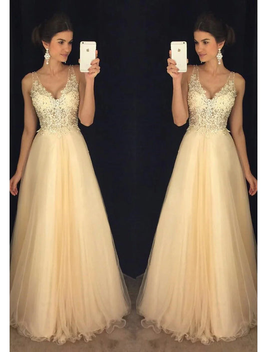 Model wearing a sparkling A-Line V-neck tulle prom dress with beading appliques, front view.