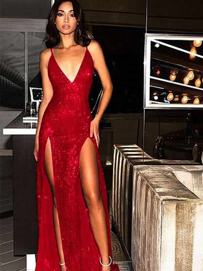 Back view of a woman in a glamorous sequined evening dress with a sweep train.