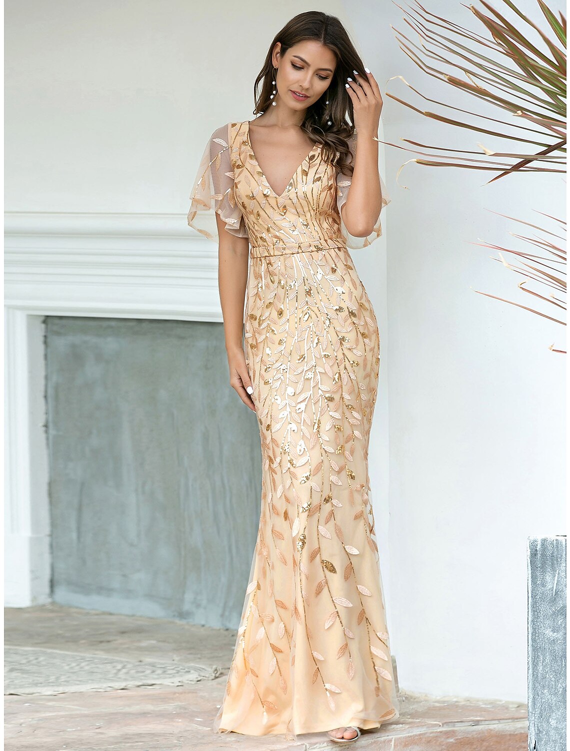 Side profile of the elegant mermaid trumpet evening gown, highlighting its silhouette.