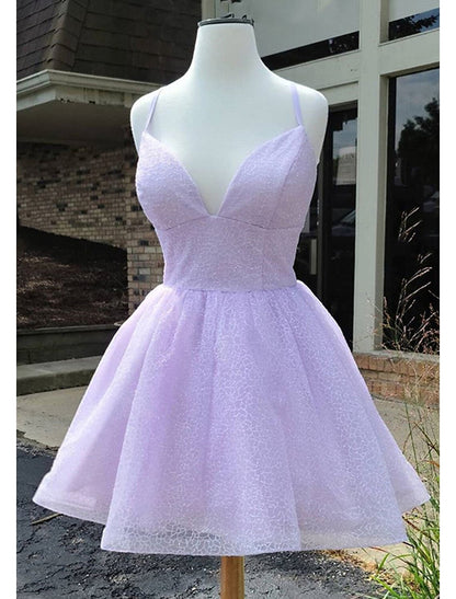 Model wearing a sparkly A-line mini homecoming dress with lace and tulle glitter.