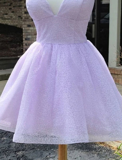 Close-up of the lace and glitter details on the sparkly A-line mini dress.
