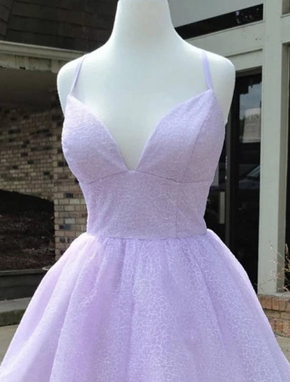 Back view of a model wearing the sparkly A-line mini homecoming dress.