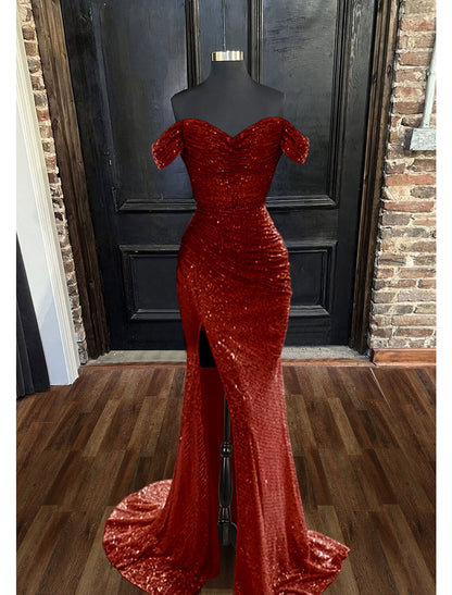 Back view of a model in a sequined floor-length prom dress.