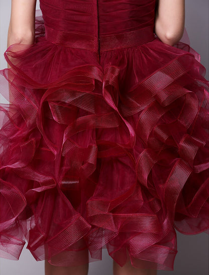 Model posing dynamically in the pink strapless cocktail dress, showing movement.