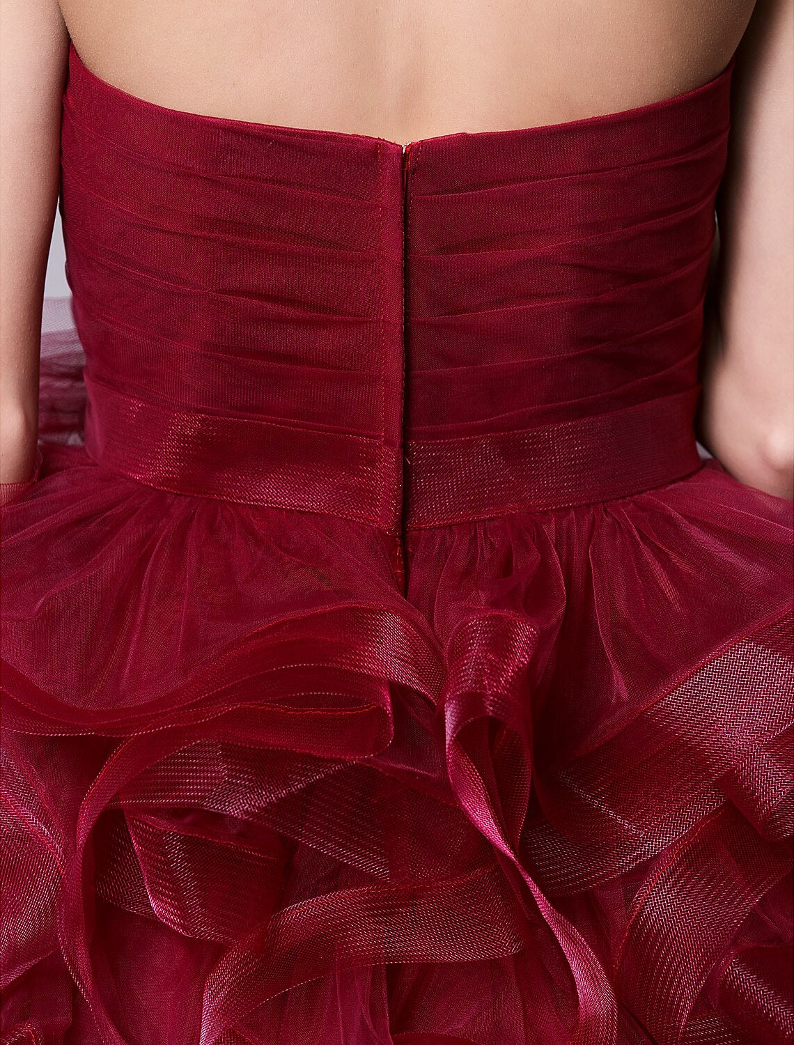 Full-length view of the pink strapless mini dress, emphasizing its short length and volume.