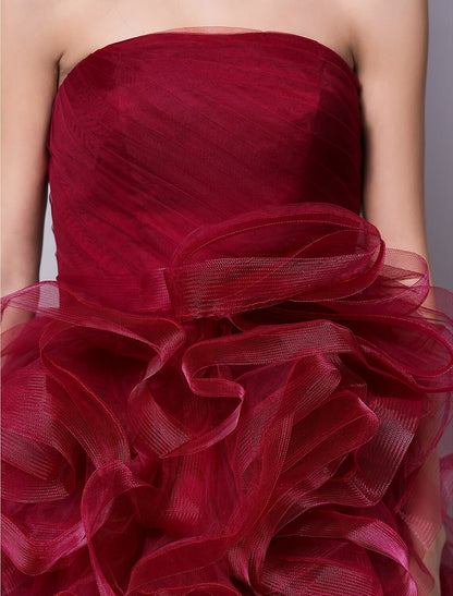 Model looking over her shoulder in the pink tulle party dress, showcasing the back.