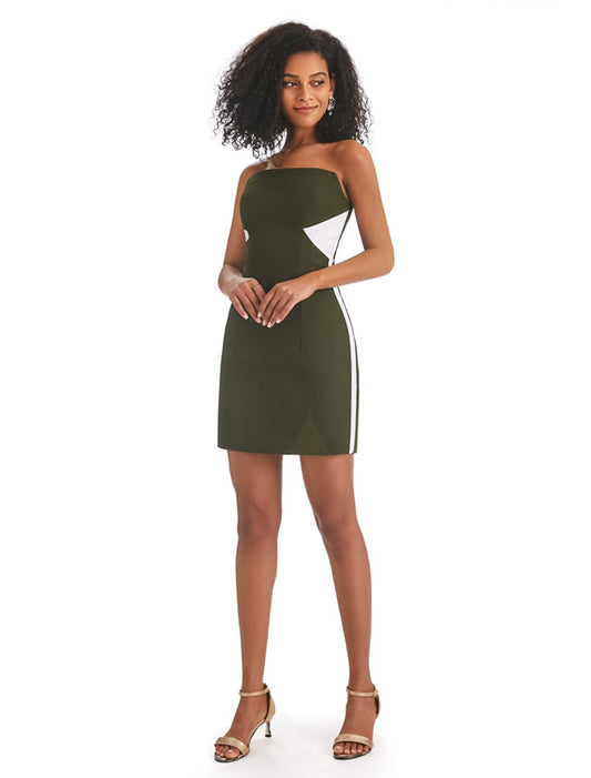 Woman in a stylish strapless color block mini dress with fringe, front view.