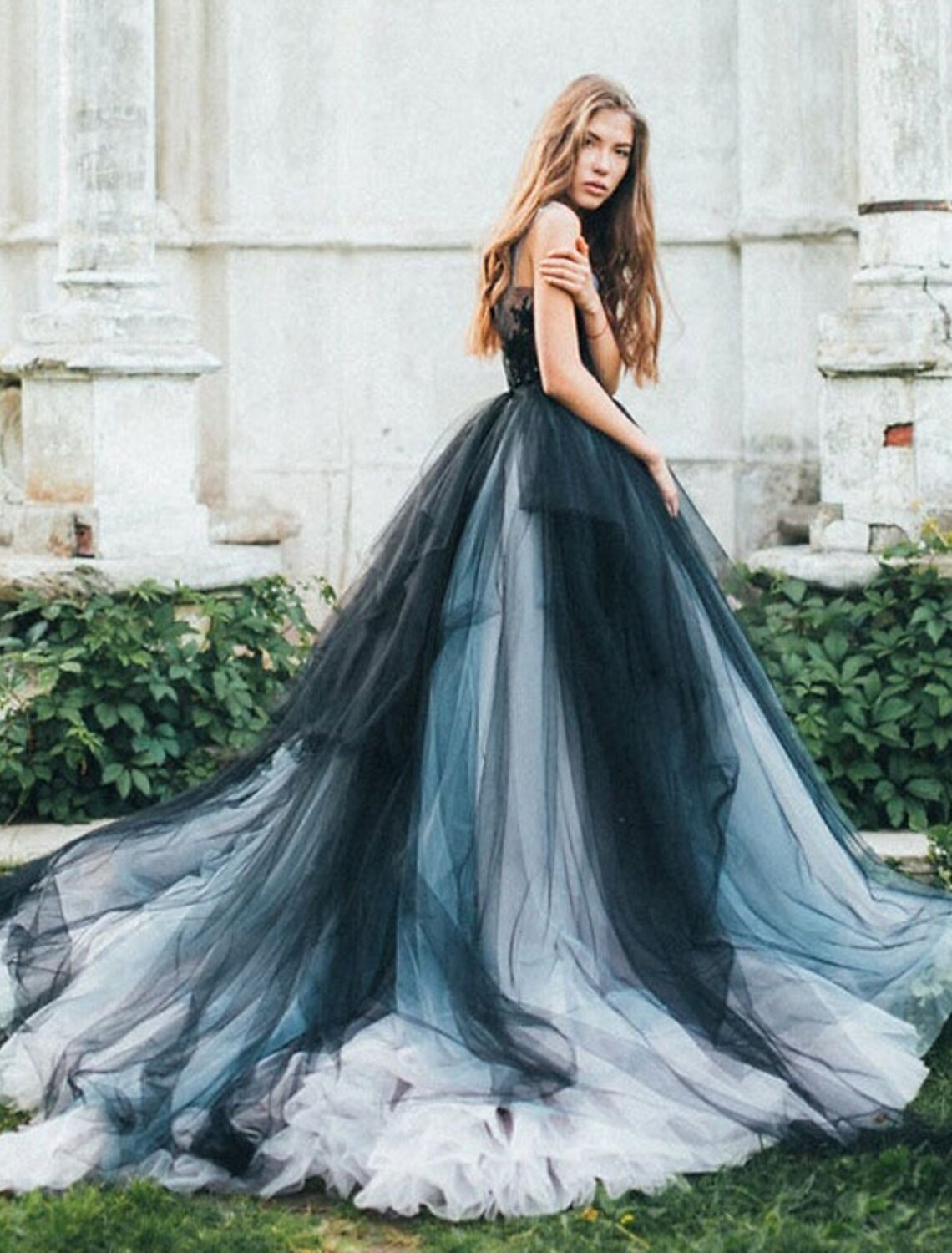 Model wearing a vibrant color block ball gown Quinceanera dress with V-neck and appliques.